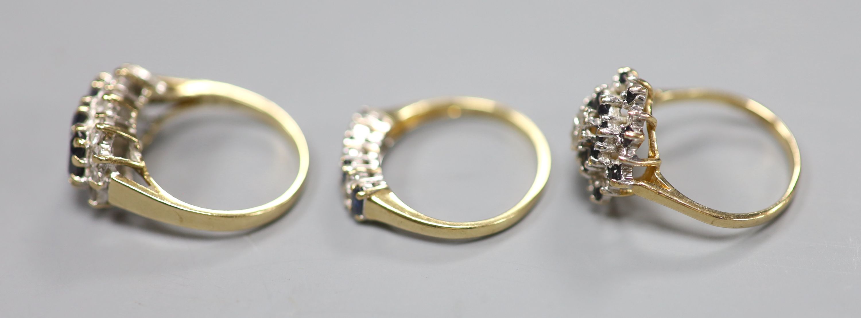 Three assorted modern 9ct gold and gem set dress rings, including one sapphire and diamond, gross weight 7.3 grams.